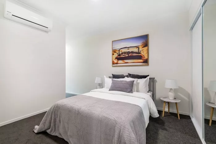 Main bedroom with built-in robes and air conditioning, Petrie Village apartment