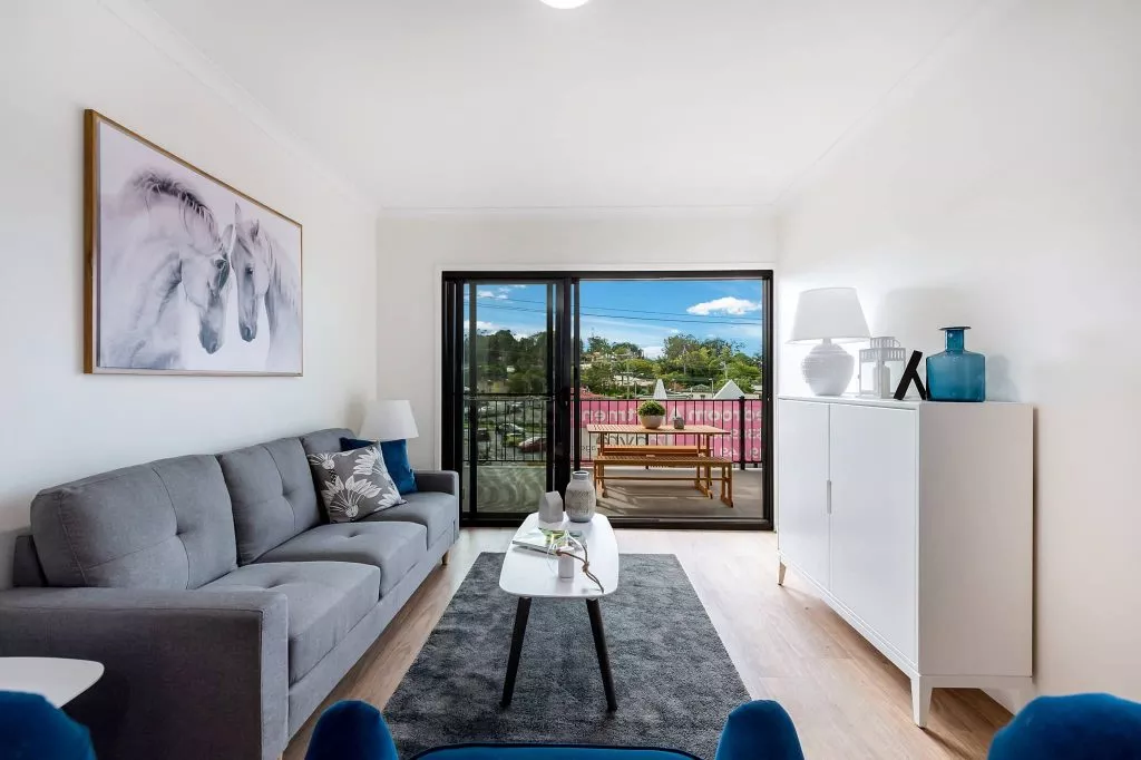 Living room of the 2 bedroom unit for rent at Petrie Village, with sliding doors to the balcony
