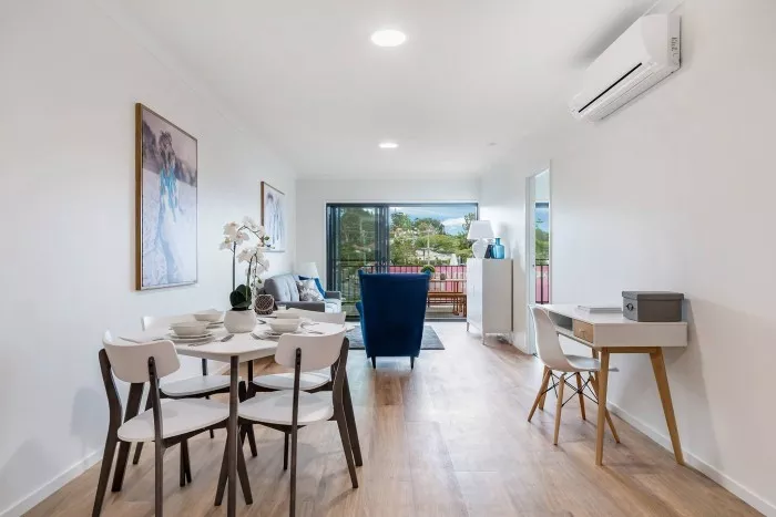 Open-plan living and dining area of the Petrie Village apartment for rent